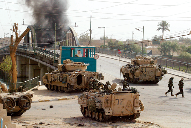 Image of US Army Soldiers Crossing a Bridge in Bahgdad